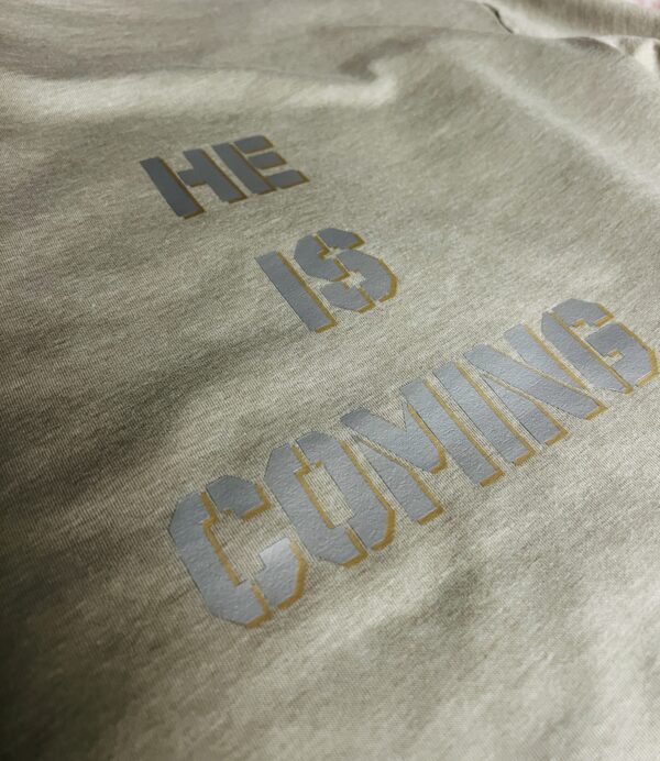 back view of a t-shirt with the sig he is coming
